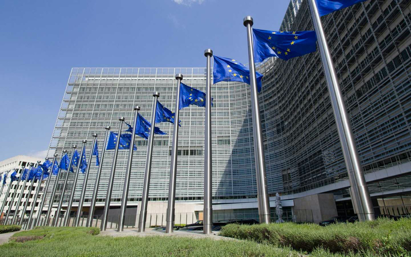 EU flags in front of the European Commission's Berlaymont building in Brussels.